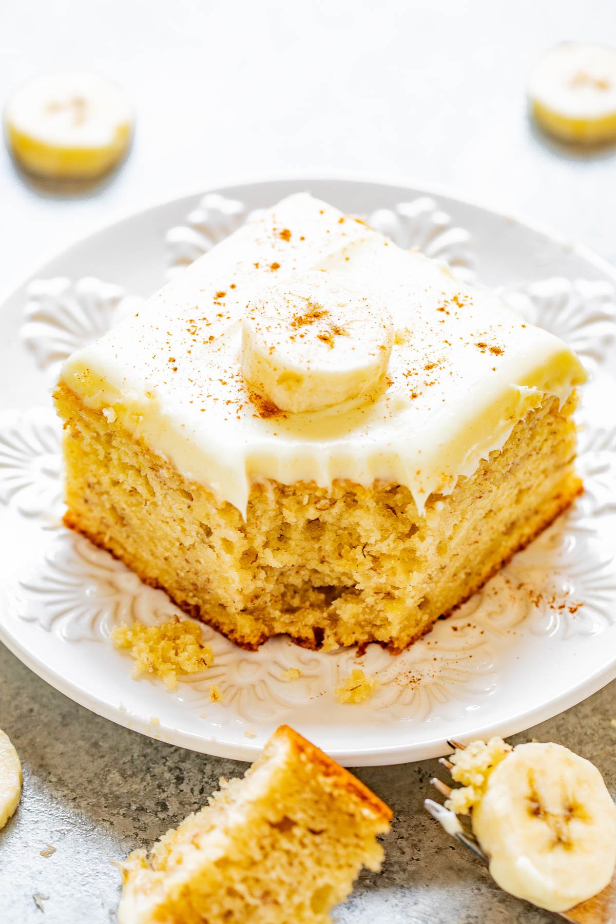 Best Banana Cake with Cream Cheese Frosting - The BEST banana cake recipe because it's soft, tender, moist, and bursting with banana flavor thanks to the 4 bananas used! Tangy-yet-sweet cream cheese frosting takes this cake over the top and makes it a guaranteed family FAVORITE! Fast and easy to make!