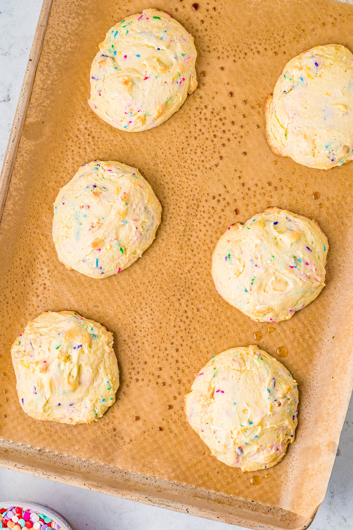 Confetti Cake Cookies (Crumbl Cookie Copycat Recipe) - Jumbo, super soft, slightly chewy cake mix cookies that are a PERFECT COPYCAT of the famous Crumbl Cookies! Loaded with rainbow and confetti sprinkles, and topped with vanilla cream cheese frosting, these are a dead ringer for the real thing!