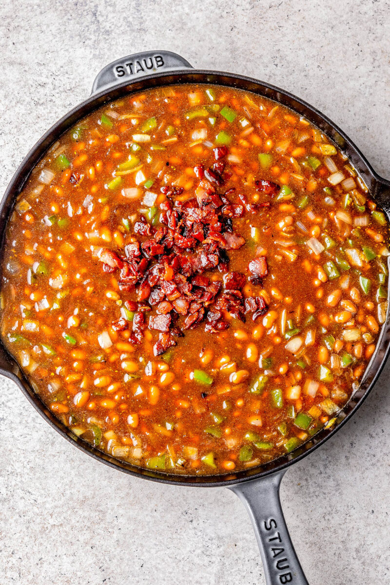 Dr Pepper baked beans with bacon in a cast-iron skillet.