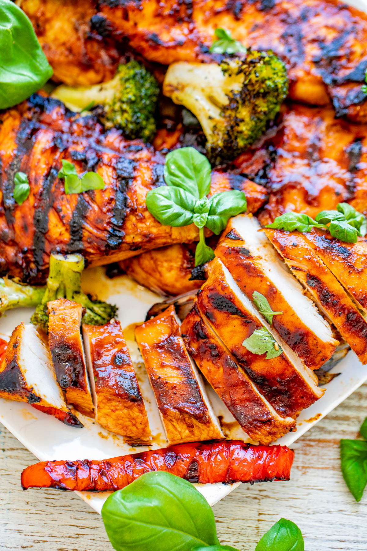 Grilled Sweet and Spicy Basil Chicken - EASY, amazing, PERFECTLY grilled chicken that's sweet-and-spicy with tons of FRESH basil flavor! Learn how to make the BEST grilled chicken and serve it with a side of lightly charred grilled vegetables! Perfect for summer barbecues, picnics, potlucks, and grilling season!