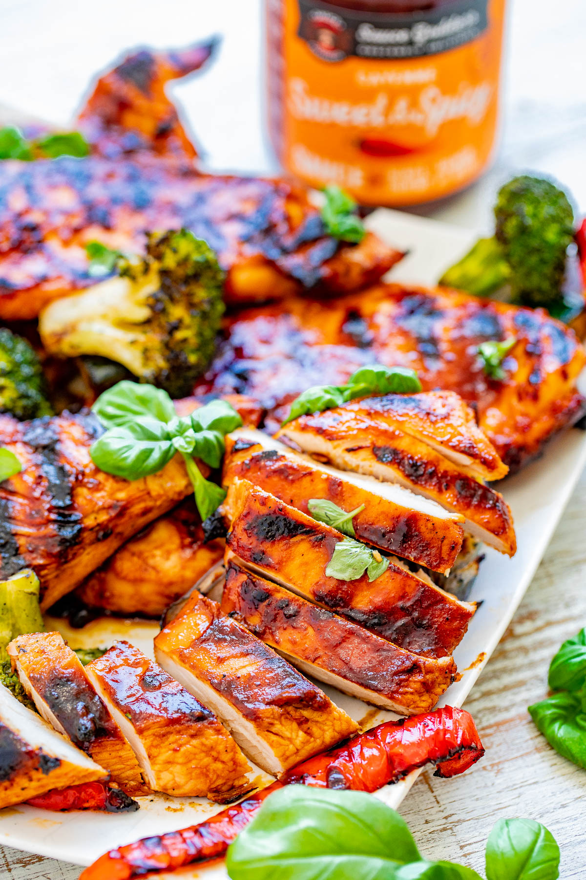 Grilled Sweet and Spicy Basil Chicken - EASY, amazing, PERFECTLY grilled chicken that's sweet-and-spicy with tons of FRESH basil flavor! Learn how to make the BEST grilled chicken and serve it with a side of lightly charred grilled vegetables! Perfect for summer barbecues, picnics, potlucks, and grilling season! 