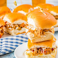Easy Pulled Pork Sliders - Moist and tender pulled pork, topped with barbecue sauce and coleslaw, and sandwiched between soft Hawaiian rolls! Everyone LOVES these EASY juicy sliders that are finger lickin' good! PERFECT for game days, casual entertaining, backyard barbecues, graduation and Father's Day celebrations.