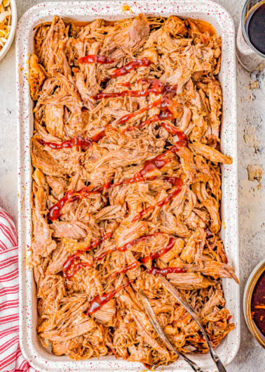 Slow Cooker Cherry Cola Pulled Pork - Super juicy, smoky, tangy-and-sweet pulled pork that is just bursting with flavor and moisture thanks to Cherry Coke and barbecue sauce! The EASIEST recipe because your Crock-Pot does all the work! Perfect for Memorial Day, Father's Day, barbecues, potlucks, game day events, and more.