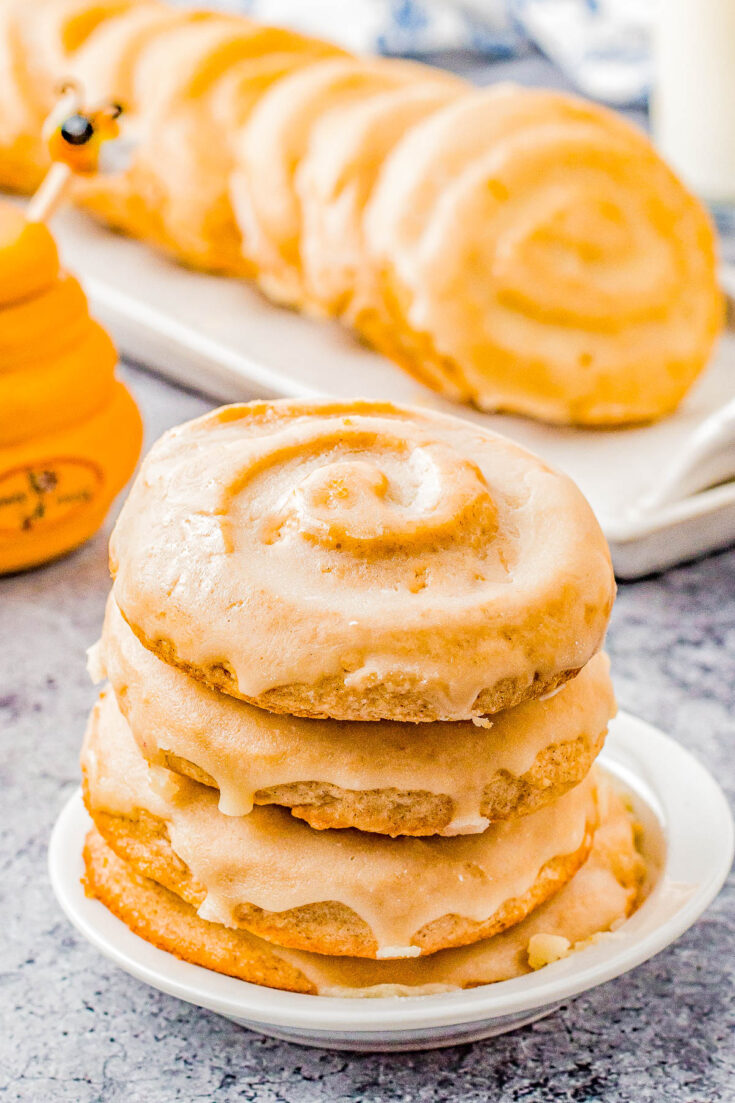 Honey Bun Cookies (Crumbl Cookies Copycat) - Soft and chewy with a warm buttery cinnamon flavor, these cookies resemble a classic Honey Bun with their fun swirl on top! The sweet honey glaze makes them IRRESISTIBLE! This EASY Crumbl Cookies copycat recipe will become a family FAVORITE!