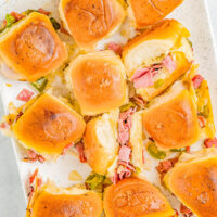Roast Beef Sliders - Tender roast beef is mixed with sauteed green peppers and onions, piled into soft Hawaiian rolls, topped with Provolone cheese, and brushed with butter and garlic before baking! These juicy sliders are fast, EASY, and perfect for Father's Day, backyard barbecues, potlucks, game day events, or anytime you need a great comfort food recipe!