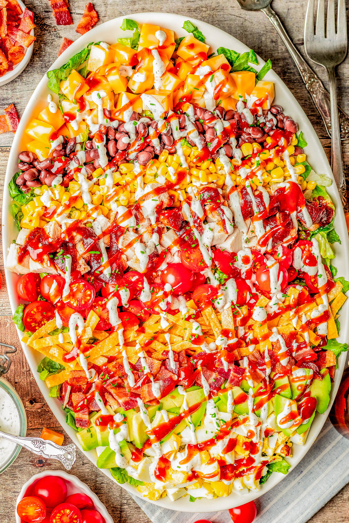Southwest Chicken Cobb Salad - A Southwestern spin on traditional Cobb salad complete with tender chicken, crispy bacon, cheese, hard-boiled eggs, tomatoes, black beans, corn, and avocado over a bed of Romaine lettuce! Topped with barbecue sauce and Ranch, there's so much FLAVOR and TEXTURE galore in every bite of this crispy, crunchy, EASY salad!