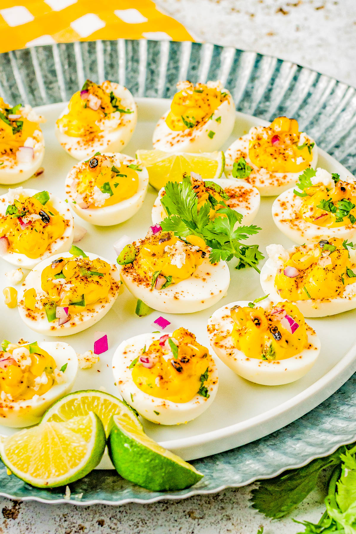 Mexican Street Corn Deviled Eggs - Deviled eggs get a south-of-the-border makeover by incorporating grilled Mexican street corn, jalapeno, red onion, cilantro, lime juice, queso fresco, and chili powder! This is an EASY appetizer or picnic recipe that everyone adores! Serve these at your next summer event including Memorial Day, Father's Day, Fourth of July, or make them for game day parties! 