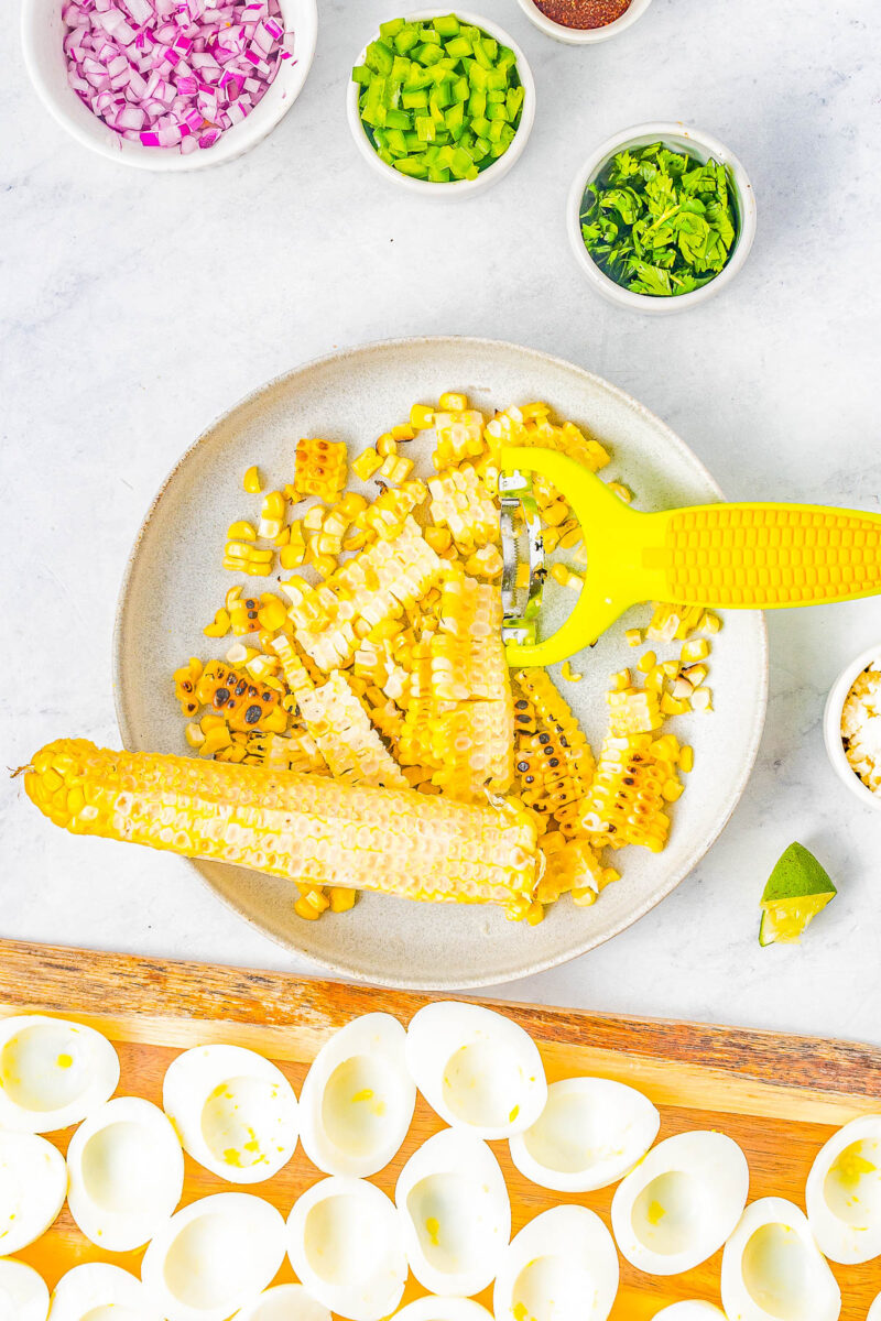 Grilled corn being removed from the cob.
