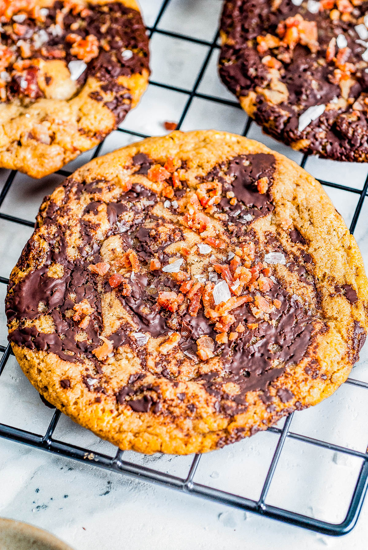 Bacon Chocolate Chip Cookies - These decadent and indulgent chocolate chip cookies are the perfect balance of savory, salty and sweet in every delectable chewy bite! With crispy bacon, butterscotch chips, tons of melted chocolate, and flaky sea salt, they're a flavor explosion for those bold enough to give them a try!