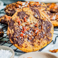 Bacon Chocolate Chip Cookies - These decadent and indulgent chocolate chip cookies are the perfect balance of savory, salty and sweet in every delectable chewy bite! With crispy bacon, butterscotch chips, tons of melted chocolate, and flaky sea salt, they're a flavor explosion for those bold enough to give them a try!