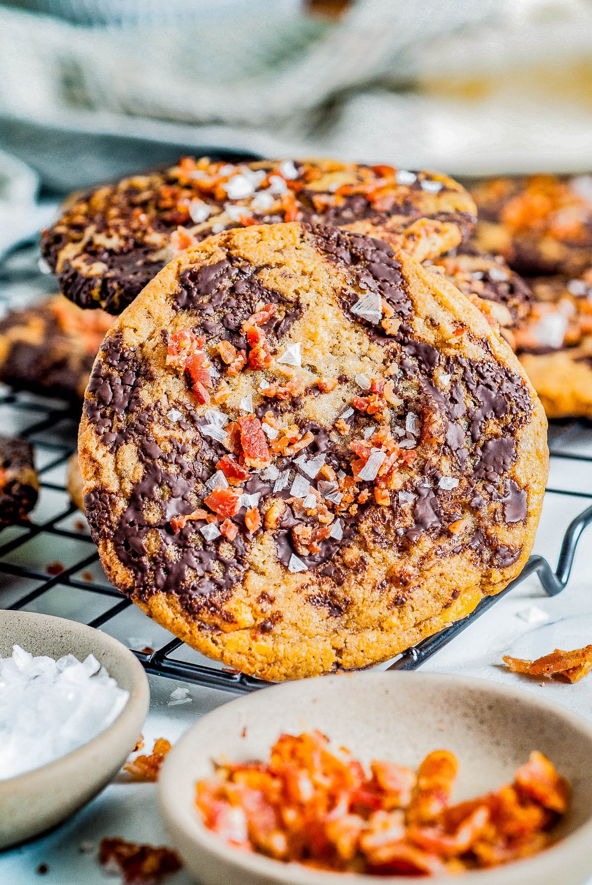 Bacon Chocolate Chip Cookies - These decadent and indulgent chocolate chip cookies are the perfect balance of savory, salty and sweet in every delectable chewy bite! With crispy bacon, butterscotch chips, tons of melted chocolate, and flaky sea salt, they're a flavor explosion for those bold enough to give them a try! 