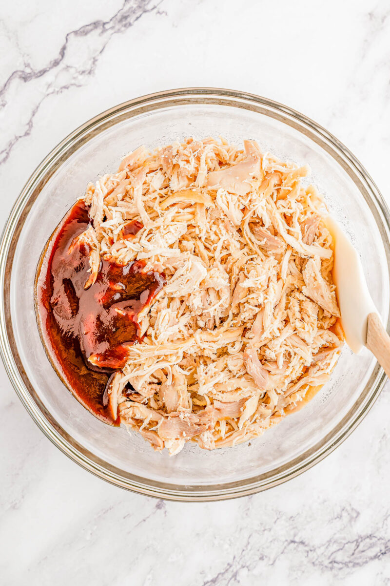Shredded chicken and BBQ sauce in a bowl.