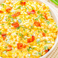 Creamy Corn and Bacon Salad - This EASY creamy corn salad with crispy bacon, jalapeño peppers and green onions for extra flavor, and plenty of shredded cheese will be a few FAVORITE side dish! Perfect for your next picnic, potluck, barbecue, or summer holiday like the 4th of July or Labor Day and it's ready in 15 minutes!