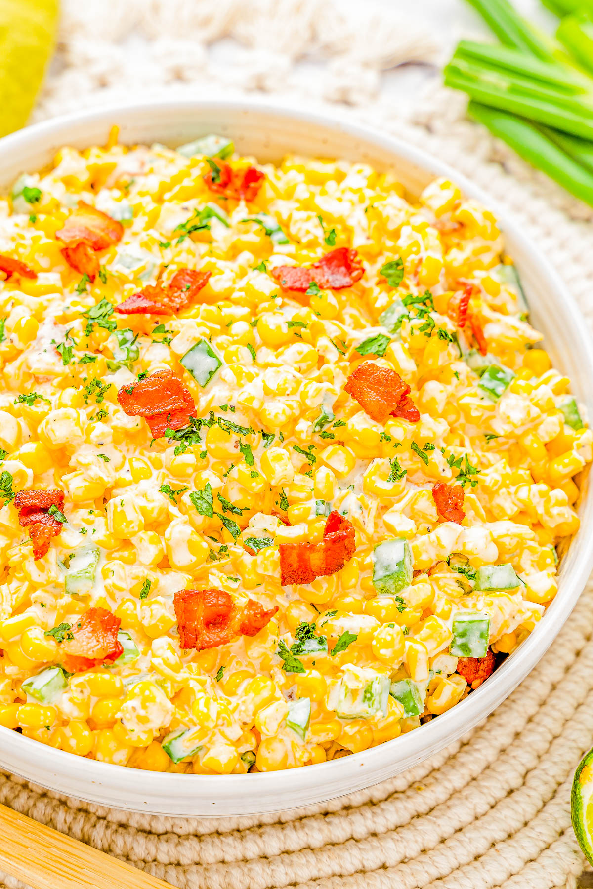 Creamy Corn and Bacon Salad - This EASY creamy corn salad with crispy bacon, jalapeño peppers and green onions for extra flavor, and plenty of shredded cheese will be a few FAVORITE side dish! Perfect for your next picnic, potluck, barbecue, or summer holiday like the 4th of July or Labor Day and it's ready in 15 minutes! 
