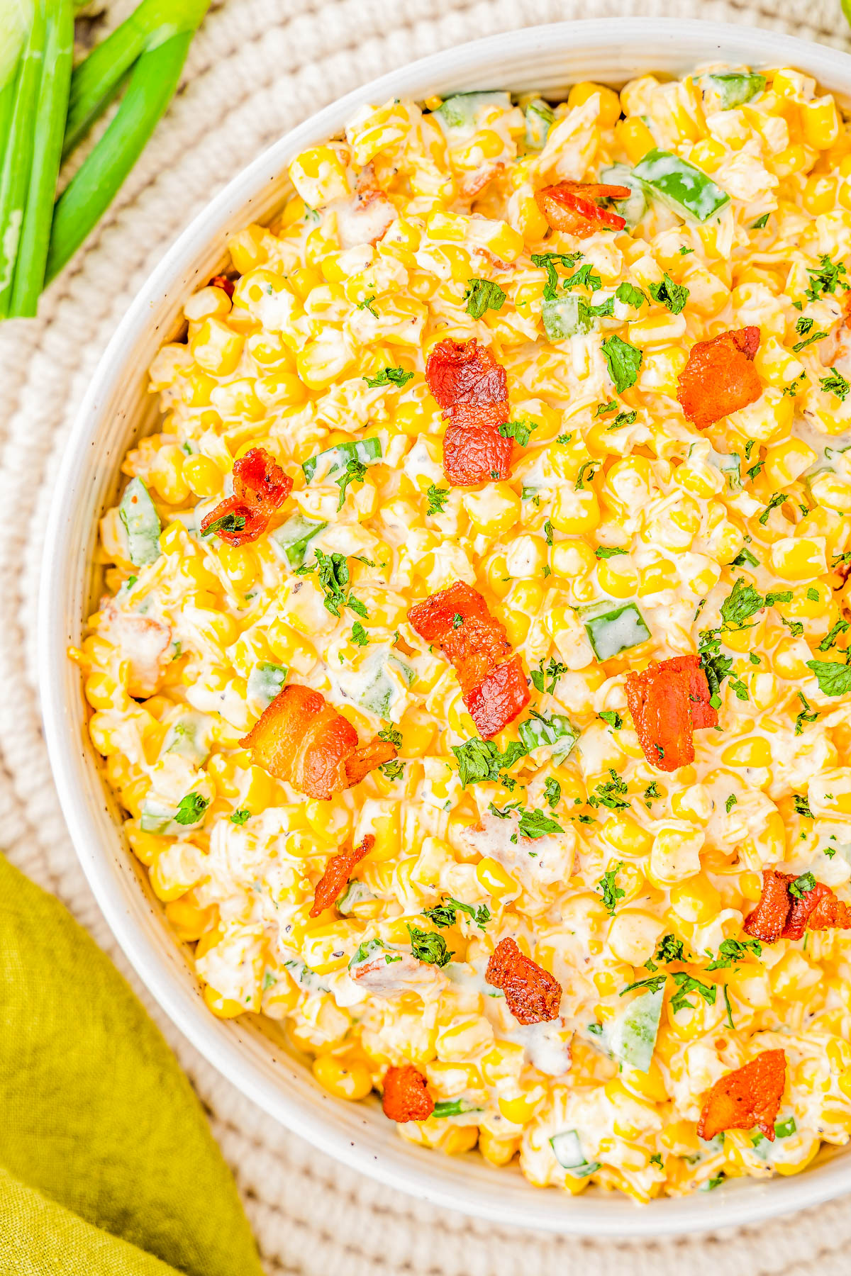 Creamy Corn and Bacon Salad - This EASY creamy corn salad with crispy bacon, jalapeño peppers and green onions for extra flavor, and plenty of shredded cheese will be a few FAVORITE side dish! Perfect for your next picnic, potluck, barbecue, or summer holiday like the 4th of July or Labor Day and it's ready in 15 minutes!