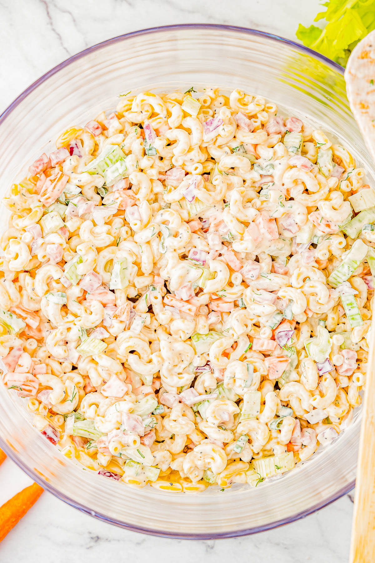 Classic Macaroni Salad - This fast and easy pasta salad recipe with tender elbow macaroni, bell peppers, carrots, celery, ham, and a super creamy dressing is a family FAVORITE! You can make it up to a day in advance if you want to get ahead and serve it at your next casual get together, backyard barbecue, picnic, potluck, or weeknight family dinner! Everyone always wants seconds!  