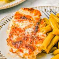 Melt In Your Mouth Chicken - This FAST and EASY baked chicken recipe transforms chicken breasts into a new dinner time FAVORITE! Tender, juicy, saucy chicken with a Parmesan topping that is incredibly flavorful and made with just FIVE main ingredients! This chicken is sure to literally melt in your mouth! 