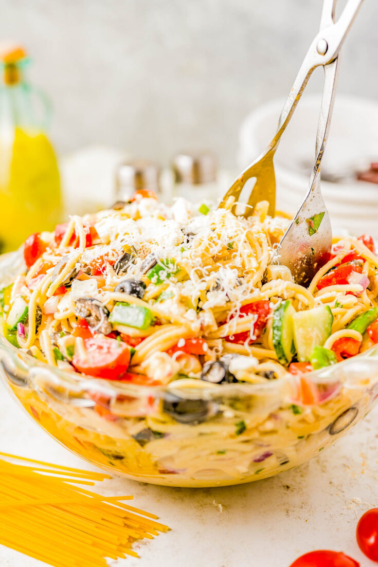 Spaghetti Pasta Salad - If you need a FAST and EASY hit for your next potluck, summer picnic, or barbeque, look no further than this spaghetti pasta salad recipe! Served chilled, it’s full of juicy cherry tomatoes, cucumbers, bell peppers, salty olives, plenty of Parmesan and feta cheese, and coated with tangy Italian dressing so it's bursting with FLAVOR!