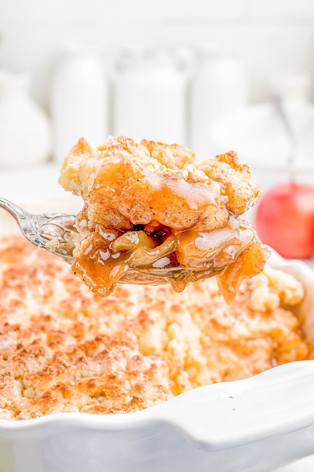 Easy Apple Cobbler — A spiced apple filling is topped with a sweet biscuit topping before being baked to golden brown and bubbly perfection! Apple cobbler is such an EASY dessert to make and tastes even better when drizzled with caramel sauce and served with a scoop of ice cream! 
