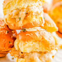 Barbecue Chicken Sliders - These FAST and EASY sliders are made with shredded chicken, smothered in tangy barbecue sauce, sandwiched between soft slider buns with cheese, and baked until warm! These pull-apart sandwiches are perfect for parties, game days, or any casual gathering where a simple appetizer or snack is needed!