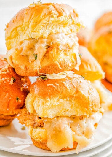 Barbecue Chicken Sliders - These FAST and EASY sliders are made with shredded chicken, smothered in tangy barbecue sauce, sandwiched between soft slider buns with cheese, and baked until warm! These pull-apart sandwiches are perfect for parties, game days, or any casual gathering where a simple appetizer or snack is needed!