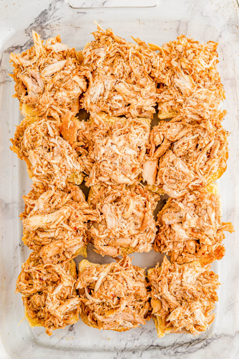 Barbecue chicken on top of Hawaiian rolls.