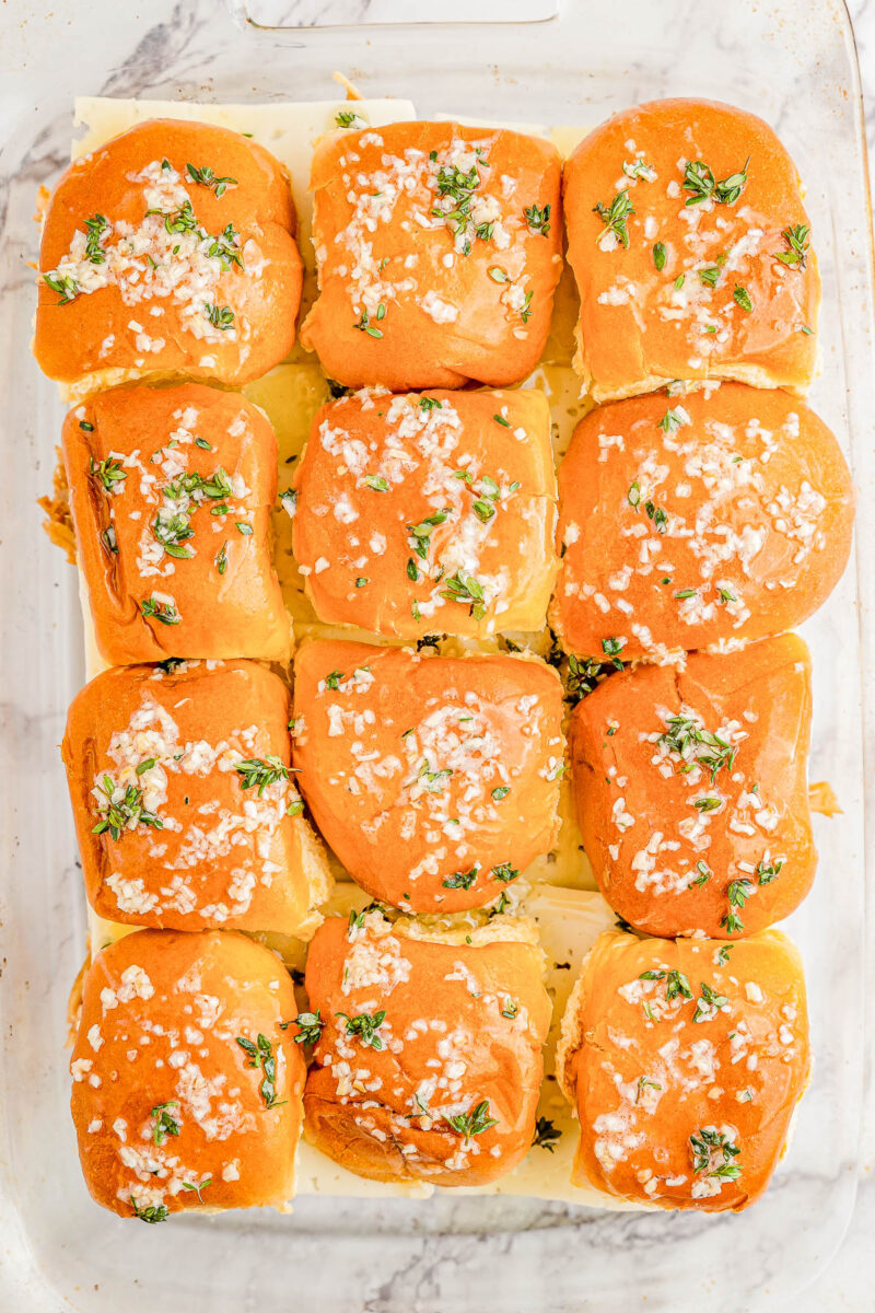 Barbecue Chicken Sliders topped with herbed garlic butter.