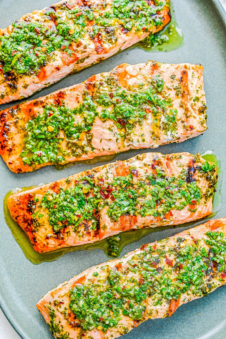 Grilled Chimichurri Salmon — Salmon filets are grilled until flaky and tender, then topped with a tangy herbed chimichurri sauce! This is a FAST and EASY grilled salmon recipe that’s ready in 20 minutes. Perfect for meal prep or whenever you’re craving a fresher and lighter summer meal that's exploding with FLAVOR!