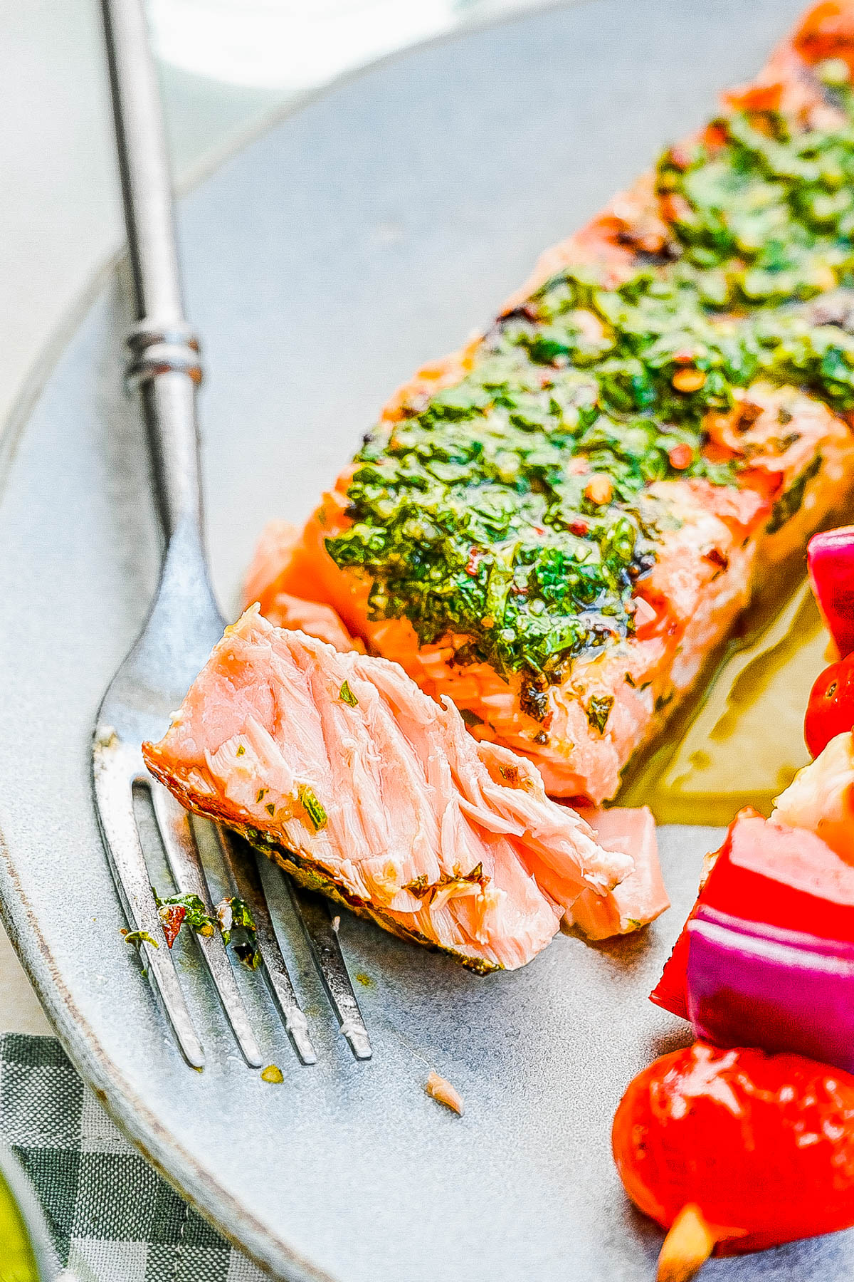Grilled Chimichurri Salmon — Salmon filets are grilled until flaky and tender, then topped with a tangy herbed chimichurri sauce! This is a FAST and EASY grilled salmon recipe that’s ready in 20 minutes. Perfect for meal prep or whenever you’re craving a fresher and lighter summer meal that's exploding with FLAVOR!