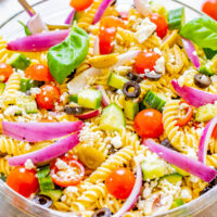 Mediterranean Pasta Salad - Juicy tomatoes and cucumbers, black and green olives, crumbled feta, and tender pasta are tossed in a homemade balsamic vinaigrette! An EASY pasta salad recipe with Mediterranean-inspired ingredients that's ready in under 30 minutes! It makes a big batch and is perfect for potlucks, picnics, or planned leftovers.