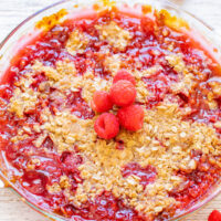 Easy Raspberry Crisp - Fresh raspberries topped with a buttery oatmeal and brown sugar crumble are the PERFECT combination! Baked to bubbly, juicy perfection and served with whipped cream or vanilla ice cream, this is a FAST and EASY summer dessert that everyone LOVES!