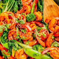 Garlic Shrimp Stir-Fry in a pot with a wooden spoon.