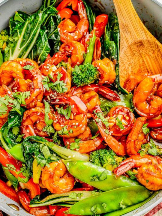 Garlic Shrimp Stir-Fry — Made with juicy shrimp, crisp-tender veggies, and a homemade stir-fry sauce, this stir-fry is QUICK and EASY! It’s ready in just 25 minutes and tastes so much better than takeout! Serve the stir-fry with noodles or rice for a complete meal. 