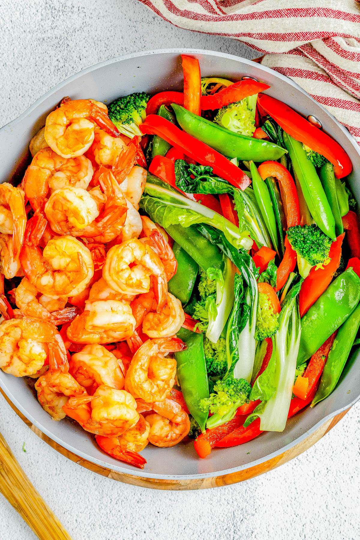 Garlic Shrimp Stir-Fry — Made with juicy shrimp, crisp-tender veggies, and a homemade stir-fry sauce, this stir-fry is QUICK and EASY! It’s ready in just 25 minutes and tastes so much better than takeout! Serve the stir-fry with noodles or rice for a complete meal.