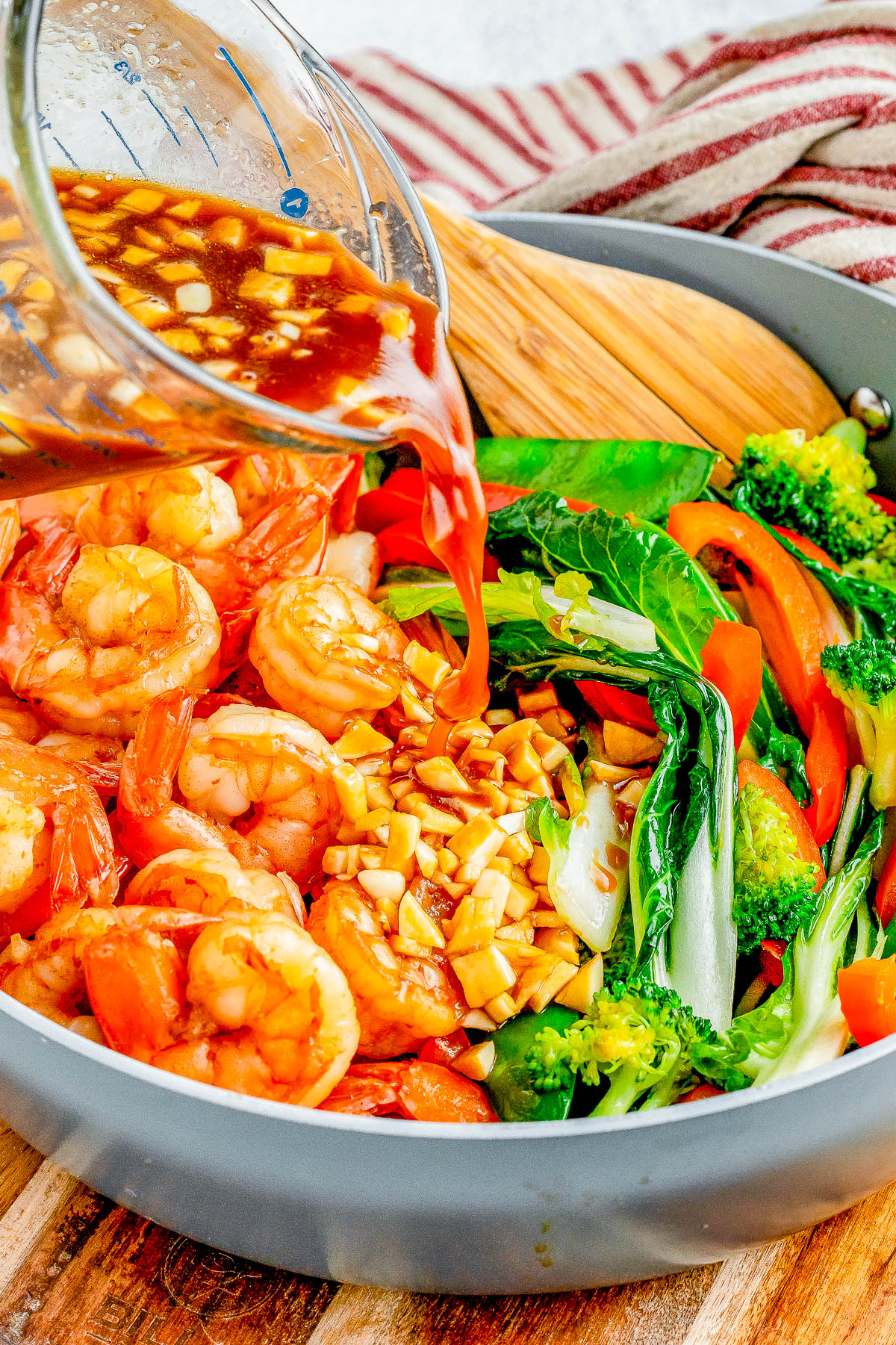 Garlic Shrimp Stir-Fry — Made with juicy shrimp, crisp-tender veggies, and a homemade stir-fry sauce, this stir-fry is QUICK and EASY! It’s ready in just 25 minutes and tastes so much better than takeout! Serve the stir-fry with noodles or rice for a complete meal.