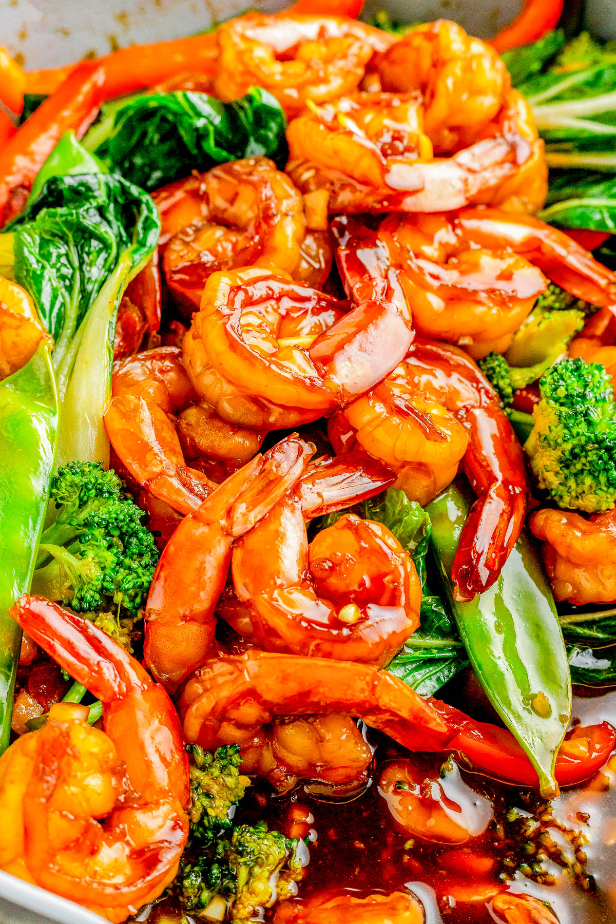 Garlic Shrimp Stir-Fry — Made with juicy shrimp, crisp-tender veggies, and a homemade stir-fry sauce, this stir-fry is QUICK and EASY! It’s ready in just 25 minutes and tastes so much better than takeout! Serve the stir-fry with noodles or rice for a complete meal. 