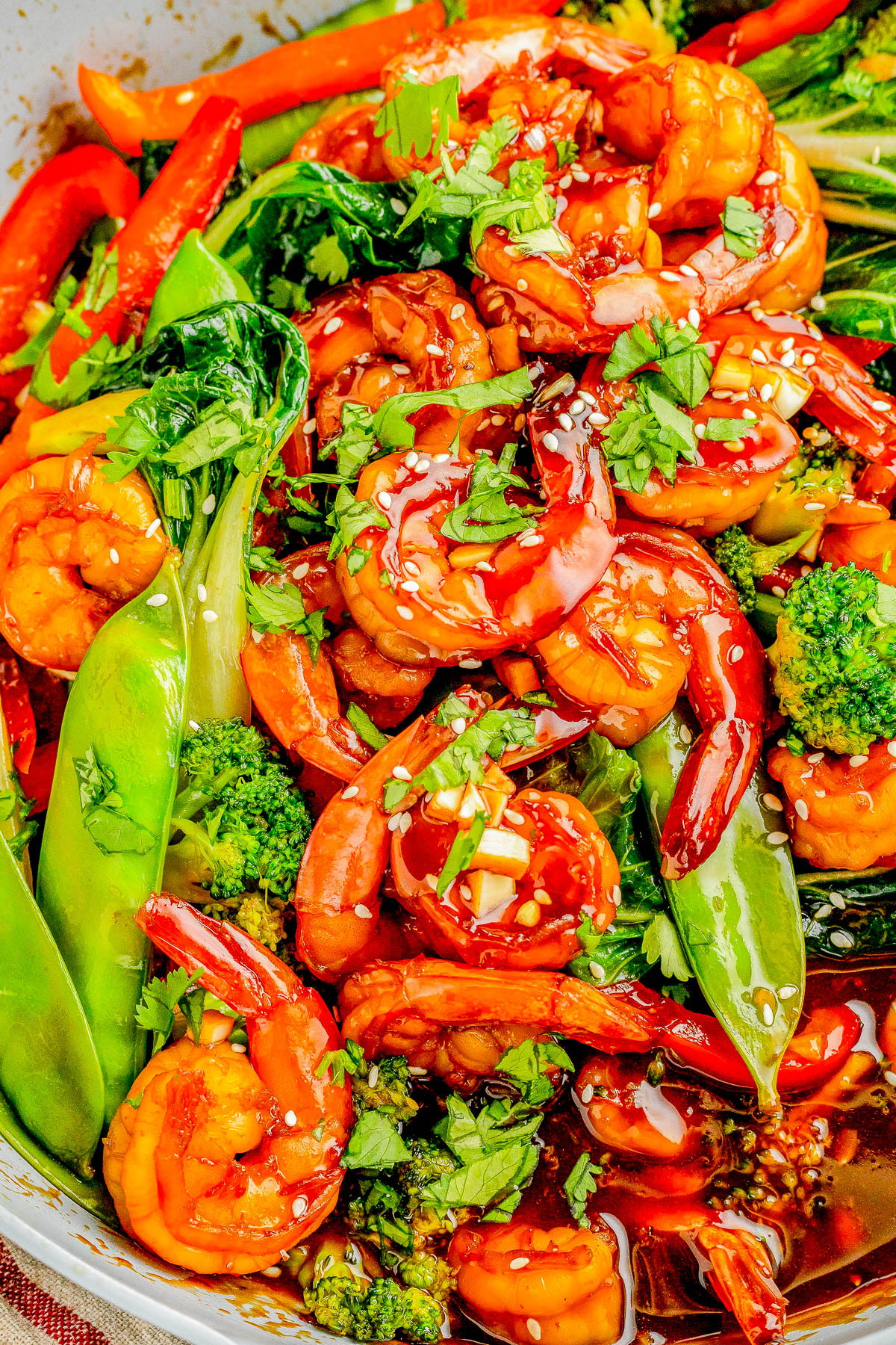 Garlic Shrimp Stir-Fry — Made with juicy shrimp, crisp-tender veggies, and a homemade stir-fry sauce, this stir-fry is QUICK and EASY! It’s ready in just 25 minutes and tastes so much better than takeout! Serve the stir-fry with noodles or rice for a complete meal. 