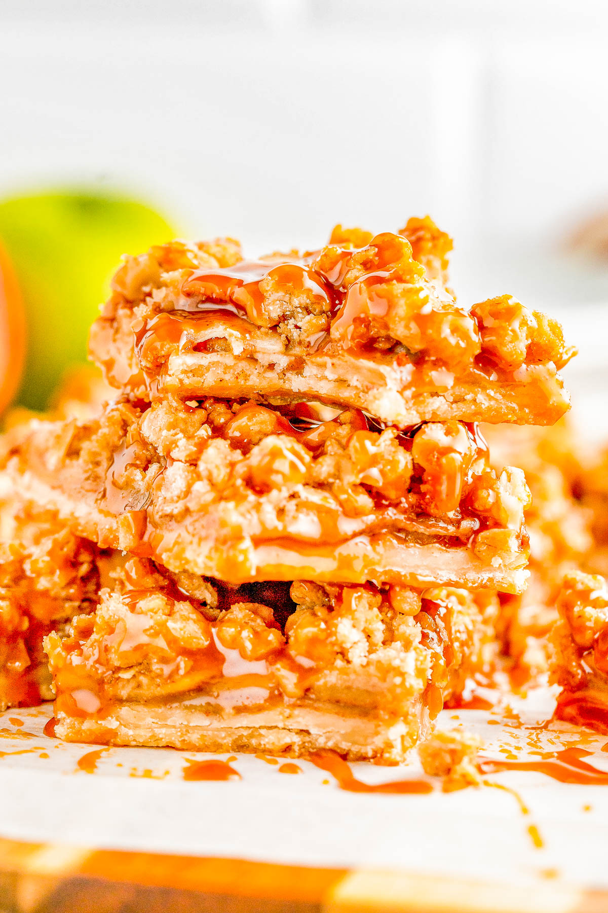 Apple Pie Bars — A flaky, buttery crust is topped with homemade apple pie filling and an oat crumble topping in these INCREDIBLE spiced apple pie bars! Salted caramel sauce is the finishing touch because nothing beats the combination of caramel and apples! Make these EASY, no-mixer bars as written for a smaller gathering, or double it for a party! 