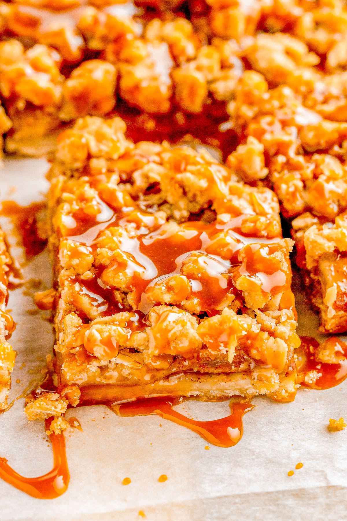 Apple Pie Bars — A flaky, buttery crust is topped with homemade apple pie filling and an oat crumble topping in these INCREDIBLE spiced apple pie bars! Salted caramel sauce is the finishing touch because nothing beats the combination of caramel and apples! Make these EASY, no-mixer bars as written for a smaller gathering, or double it for a party! 