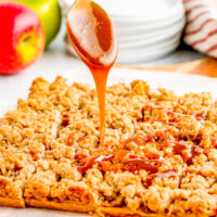 Apple Pie Bars being topped with caramel sauce.