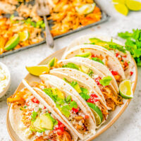 Slow Cooker Chicken Carnitas - These EASY and flavorful chicken carnitas are seasoned with Mexican spices, citrus juices, chipotle peppers in adobo and slow-cooked to PERFECTION! A quick trip under the broiler ensures those traditional crispy bits and then it's ready to use in tacos, burritos, salads, or other Mexican-inspired dishes for a simple but family FAVORITE weeknight dinner! 