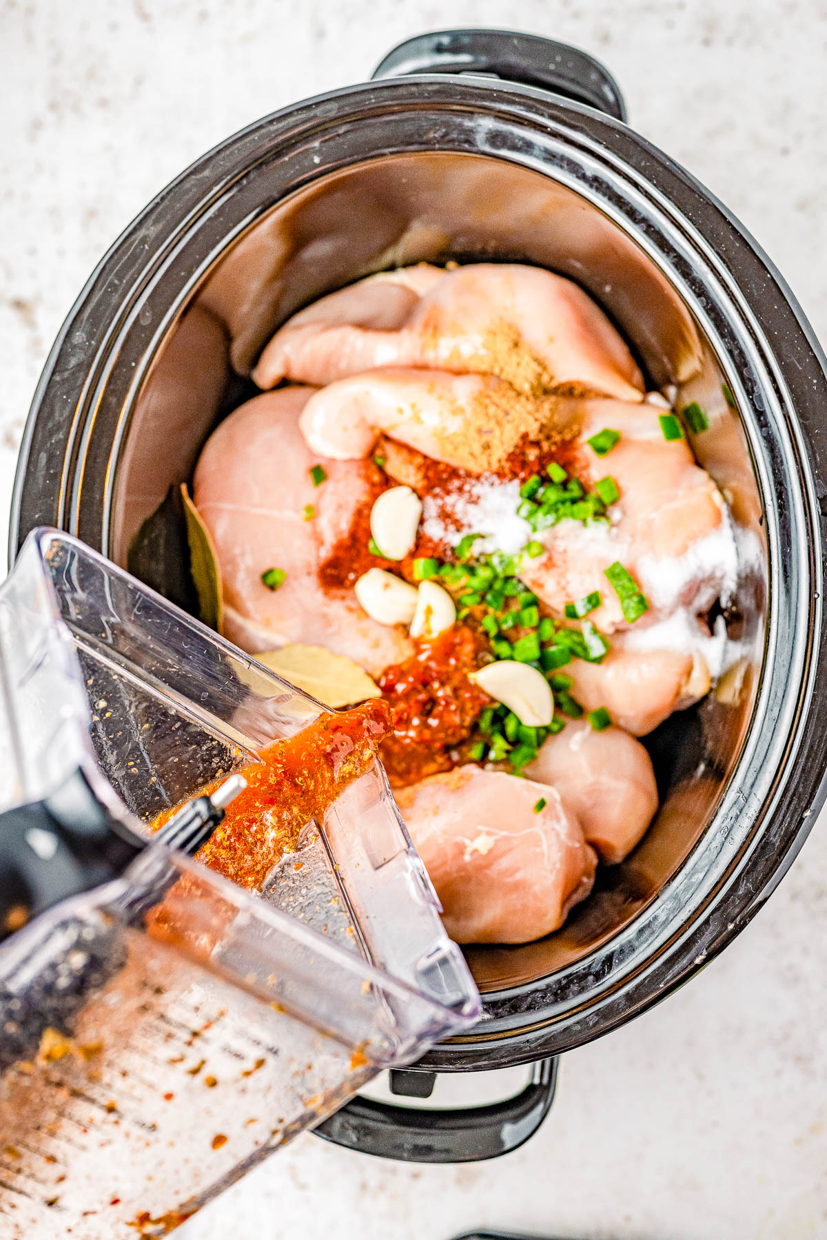 Slow Cooker Chicken Carnitas - These EASY and flavorful chicken carnitas are seasoned with Mexican spices, citrus juices, chipotle peppers in adobo and slow-cooked to PERFECTION! A quick trip under the broiler ensures those traditional crispy bits and then it's ready to use in tacos, burritos, salads, or other Mexican-inspired dishes for a simple but family FAVORITE weeknight dinner! 