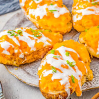 Buffalo Chicken Stuffed Potatoes – If you love the tang and heat of buffalo chicken wings, then you're going to love these EASY stuffed potatoes! Chock full of shredded buffalo chicken, cheddar and mozzarella cheeses, cream cheese, and sour cream, I promise these are a COMFORT FOOD delight! Whether you make them as a main dish for a weeknight dinner, as a party appetizer, or as a game day snack, everyone LOVES them!