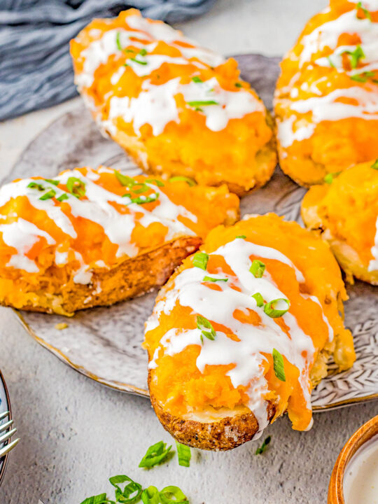 Buffalo Chicken Stuffed Potatoes – If you love the tang and heat of buffalo chicken wings, then you're going to love these EASY stuffed potatoes! Chock full of shredded buffalo chicken, cheddar and mozzarella cheeses, cream cheese, and sour cream, I promise these are a COMFORT FOOD delight! Whether you make them as a main dish for a weeknight dinner, as a party appetizer, or as a game day snack, everyone LOVES them!