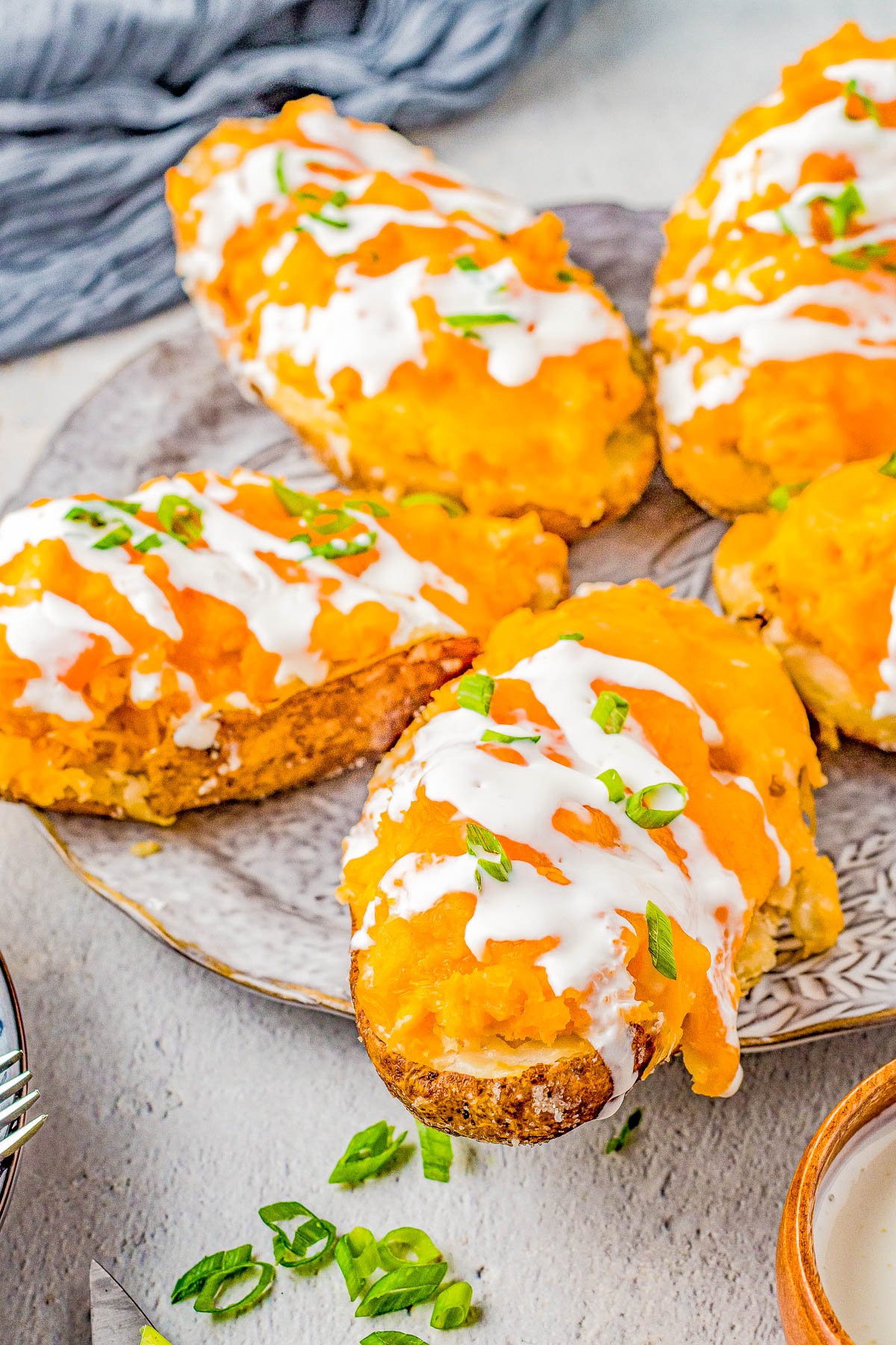 Buffalo Chicken Stuffed Potatoes – If you love the tang and heat of buffalo chicken wings, then you're going to love these EASY stuffed potatoes! Chock full of shredded buffalo chicken, cheddar and mozzarella cheeses, cream cheese, and sour cream, I promise these are a COMFORT FOOD delight! Whether you make them as a main dish for a weeknight dinner, as a party appetizer, or as a game day snack, everyone LOVES them! 