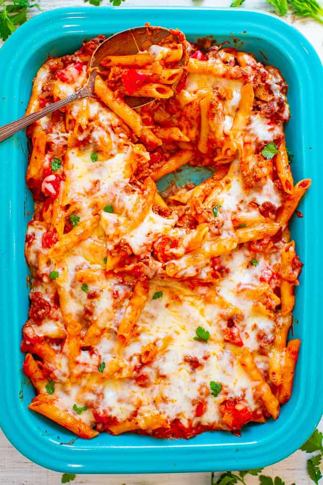 Cheesy Ground Beef Pasta Casserole — Hearty comfort food that's EASY and IRRESISTIBLE!! Cheesy pasta and beef coated in marinara sauce and topped with more CHEESE! Makes planned leftovers and is freezer-friendly!!