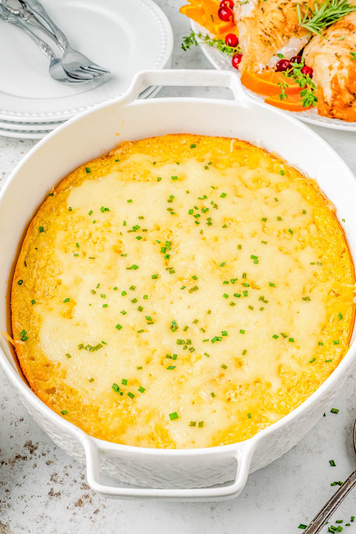 Creamed Corn Casserole — The EASIEST holiday side dish you’ll ever make! This CREAMY, cheesy corn casserole is a simple stir-and-bake affair that can be made in advance! The texture is a cross between a souffle and cornbread. Slightly gooey, slightly firm, and pairs perfectly with your favorite Thanksgiving, Christmas, and Easter dishes!   