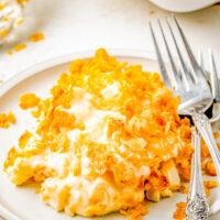 Cheesy Funeral Potatoes on a plate with two forks.