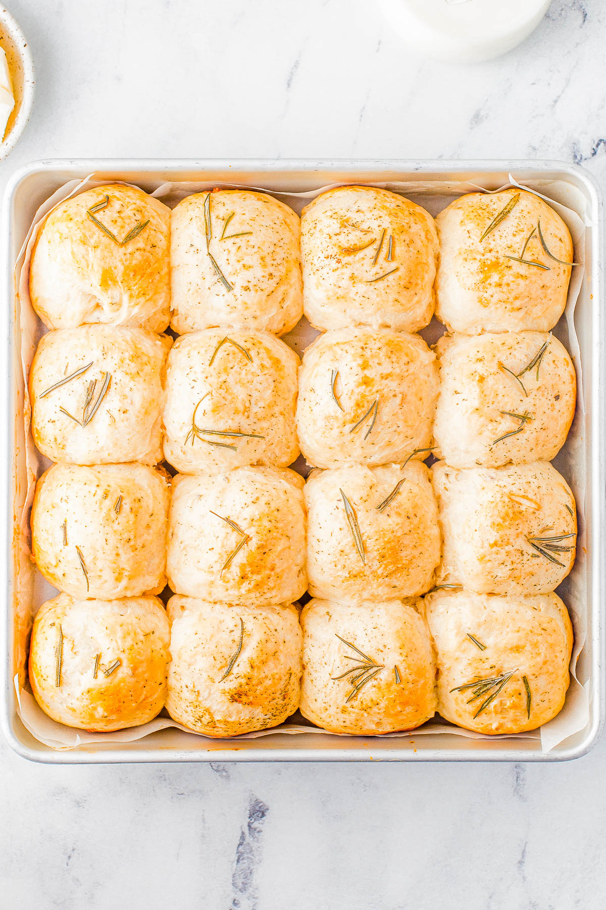 Garlic Herb Rolls - Indulge in the perfect holiday side dish with a basket of homemade garlic and herb rolls! Made with plenty of garlic, fresh rosemary and herbs, these soft dinner rolls are a must-have for family dinners or celebration meals like Thanksgiving and Christmas. Even if you've never made homemade dinner rolls, don't worry because I explain it all and walk you through the steps, and make it EASY for you to master homemade rolls!