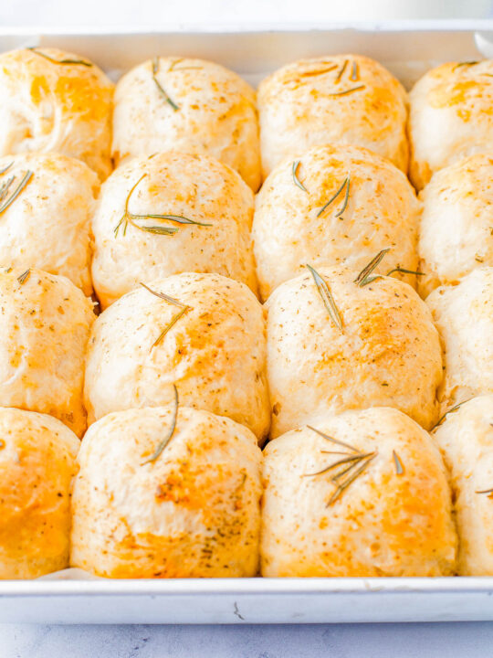 Garlic Herb Rolls - Indulge in the perfect holiday side dish with a basket of homemade garlic and herb rolls! Made with plenty of garlic, fresh rosemary and herbs, these soft dinner rolls are a must-have for family dinners or celebration meals like Thanksgiving and Christmas. Even if you've never made homemade dinner rolls, don't worry because I explain it all and walk you through the steps, and make it EASY for you to master homemade rolls!
